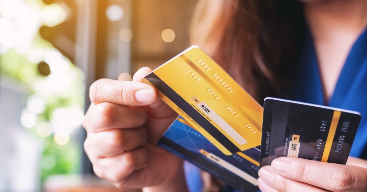 woman choosing card for making purchase