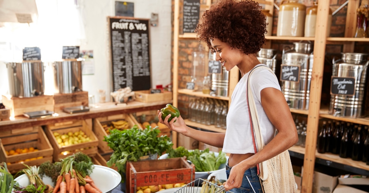 woman buying organic vegetables at store