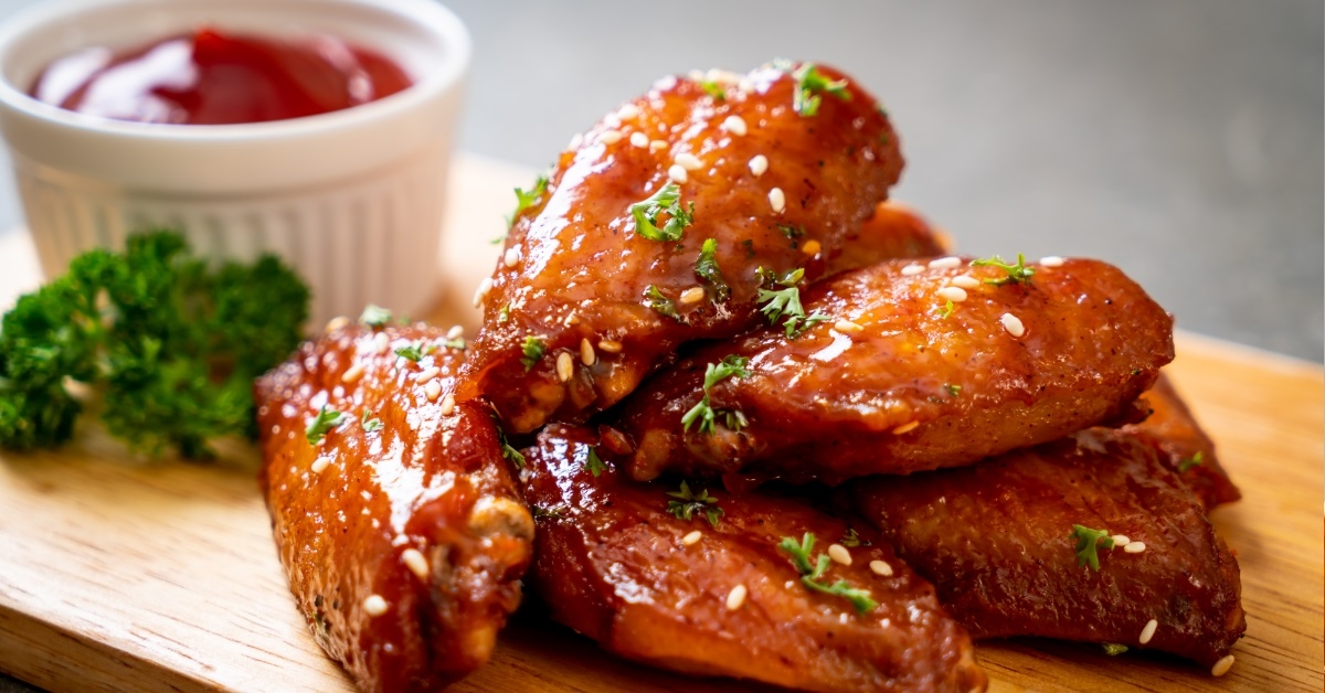 barbecue chicken wings on wooden board