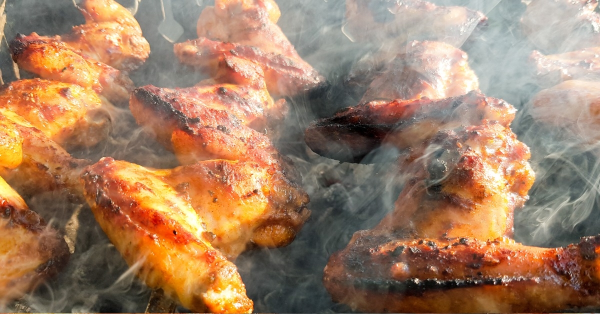 chicken wings getting smoked outdoors