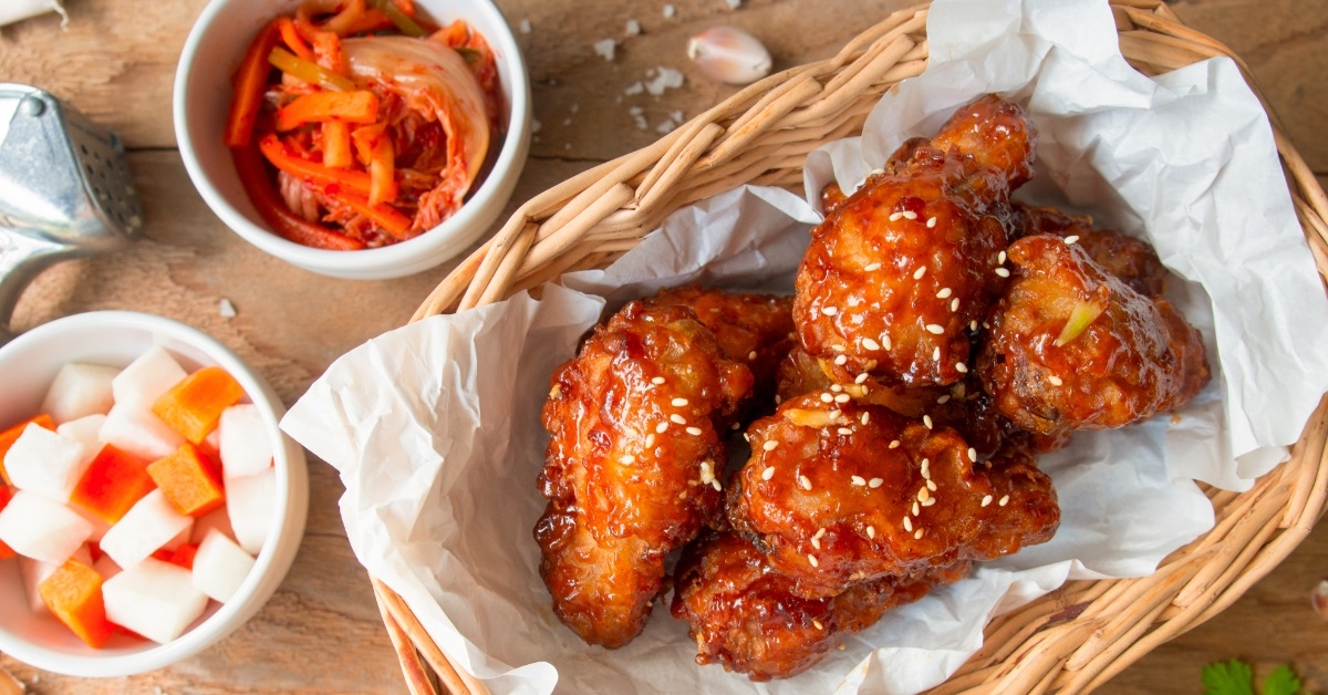 marinated chicken wings besides kimchi bowl
