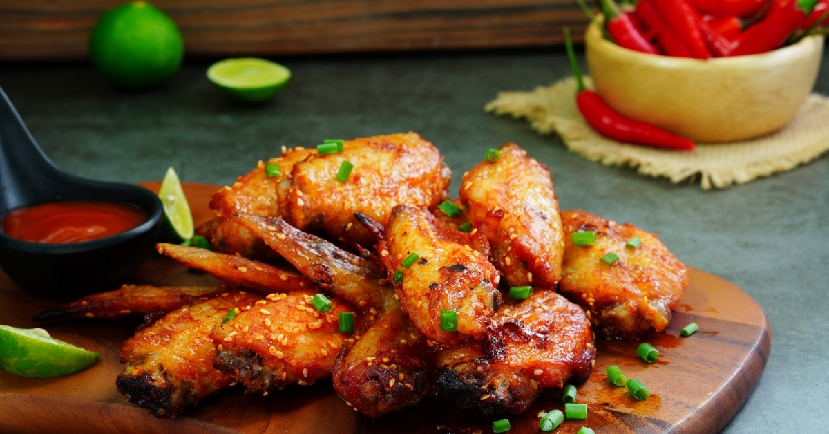 crispy chicken wings on wooden board