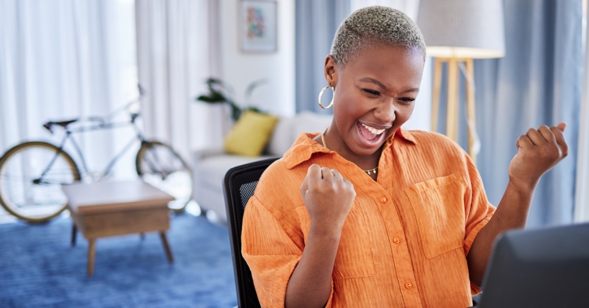 woman cheering after completing project online