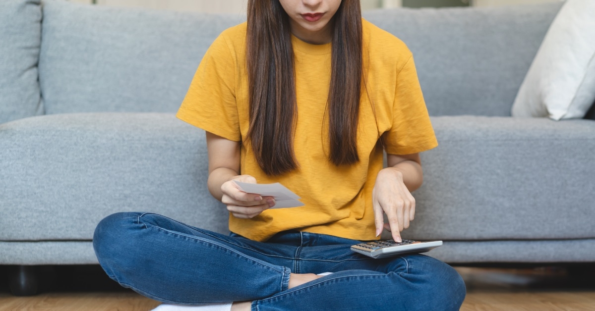 young woman calculating monthly expenses