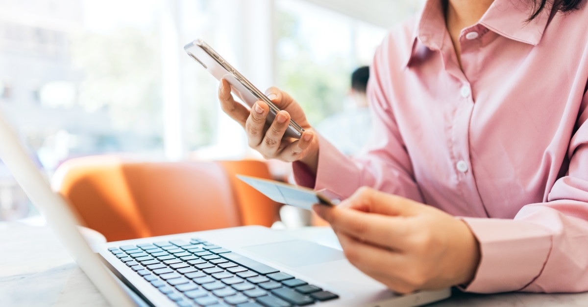 woman using card and smartphone
