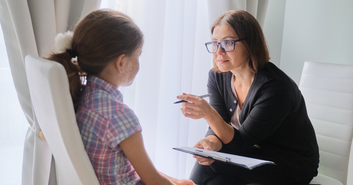 woman social worker talking to girl