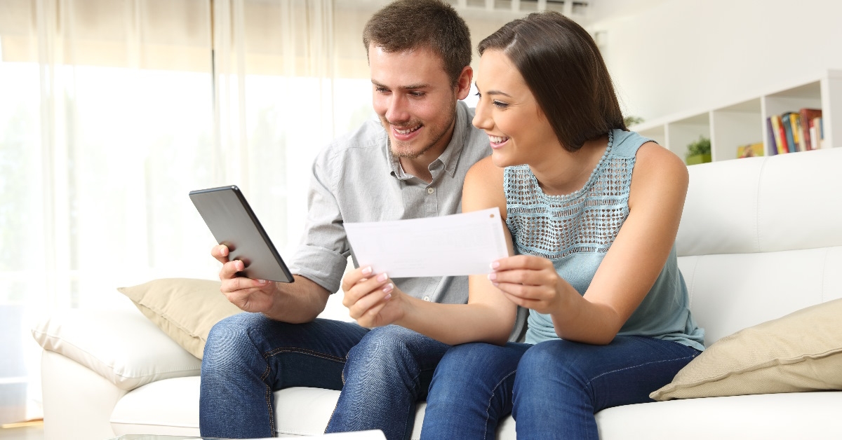 Happy couple checking bank account online.