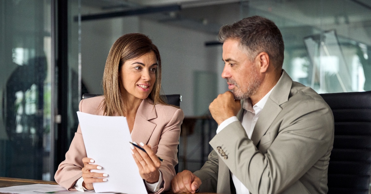 A team leader is talking to her colleague in office.