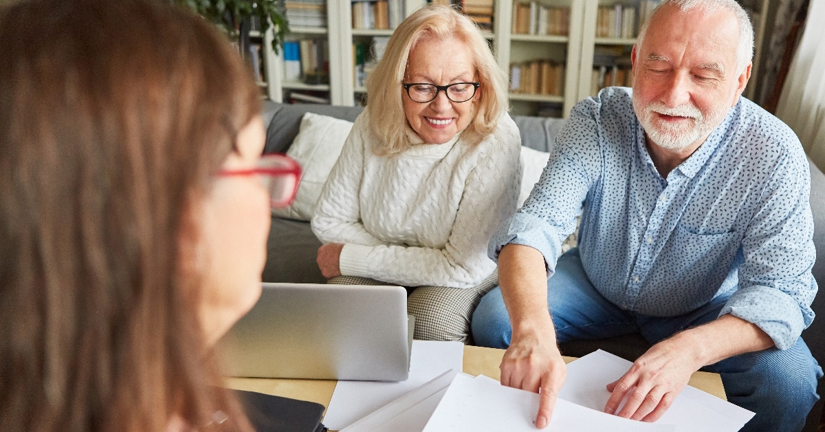 senior pair conversing with financial advisor