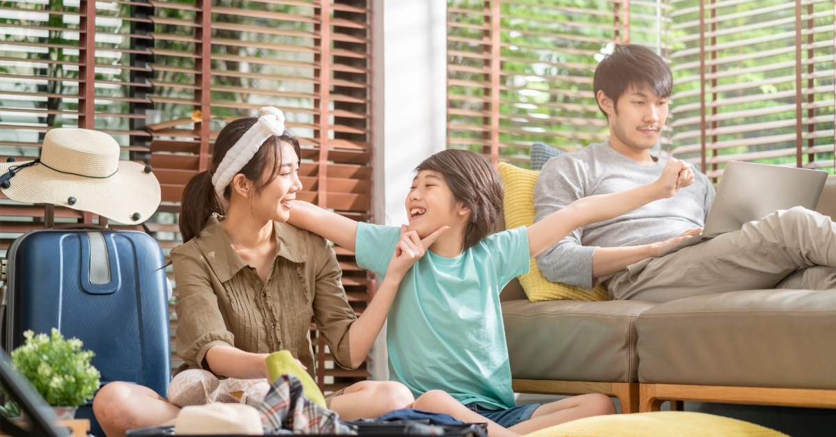 happy asian family packing for vacation