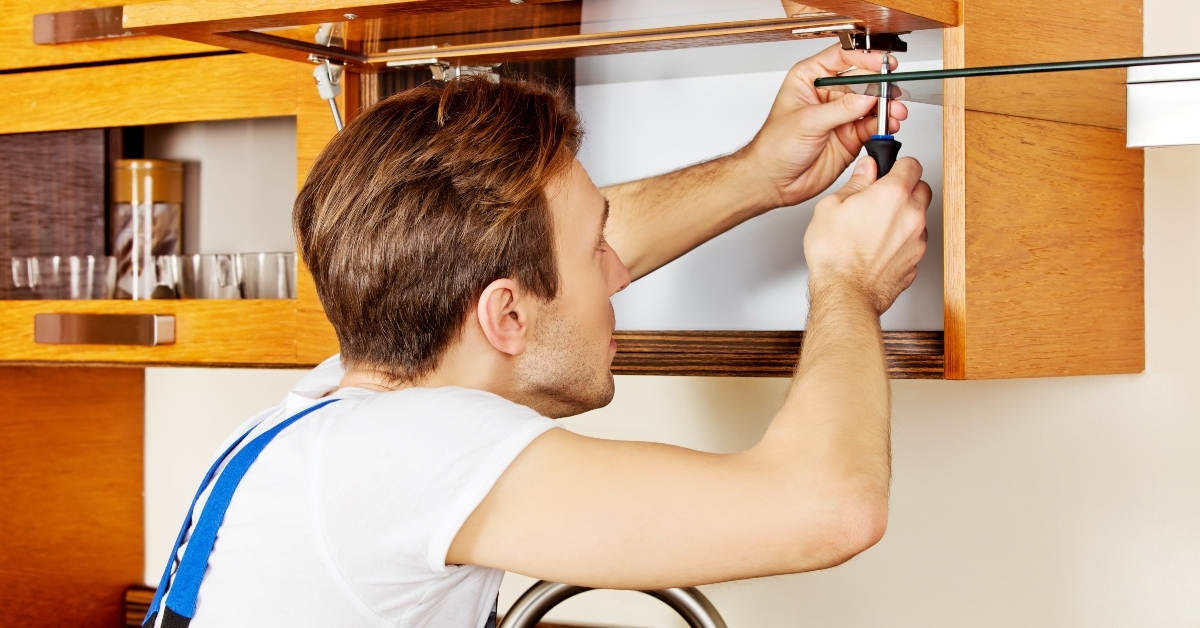 fixing kitchens cabinet with screwdriver