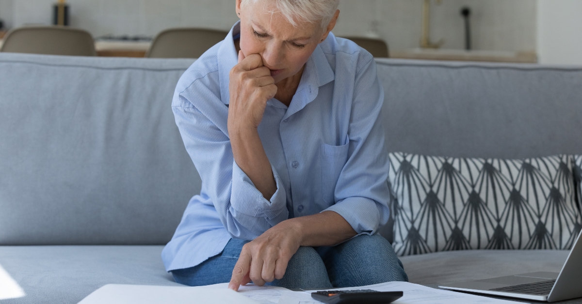 upset older woman sit on sofa