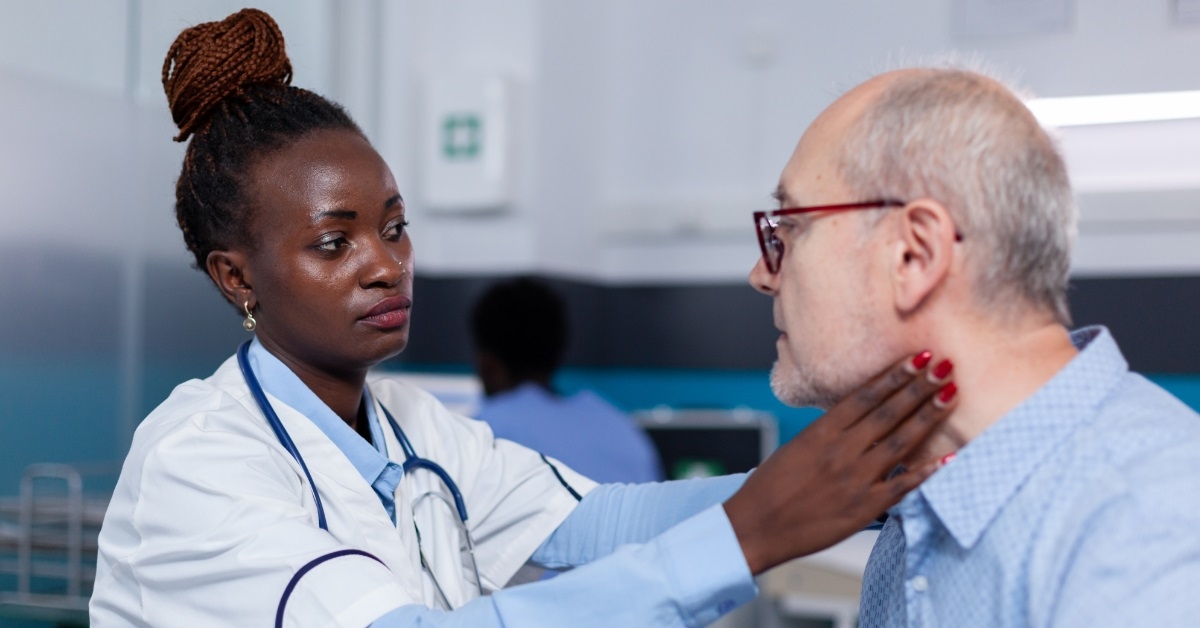 african american doctor checking senior male