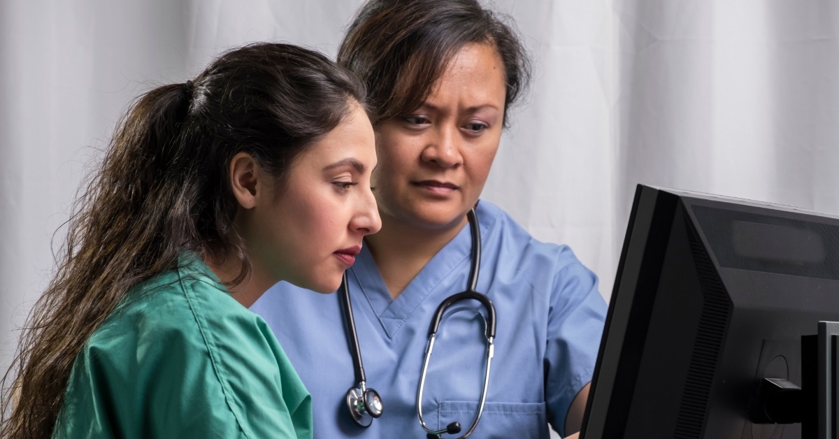 female doctors reading reports on computer