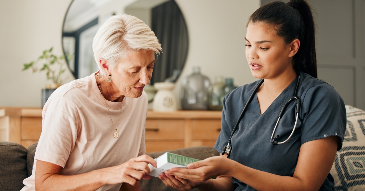 nurse explaining medication to senior woman