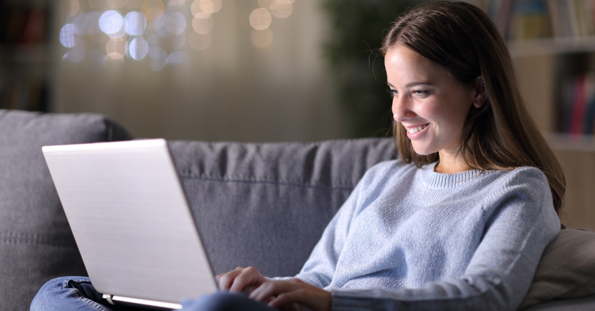 woman using laptop on a couch