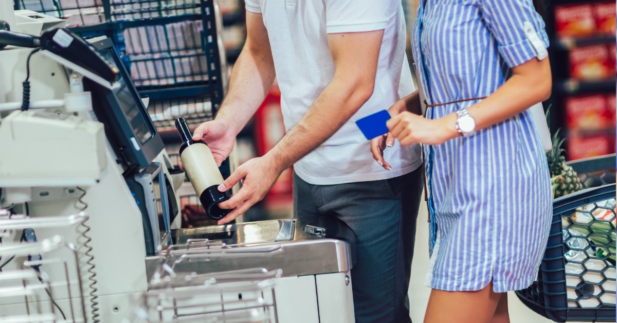 couple using card at self checkout