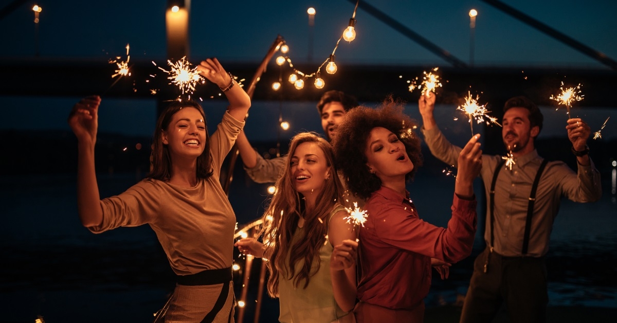 friends enjoying fire crackers on terrace