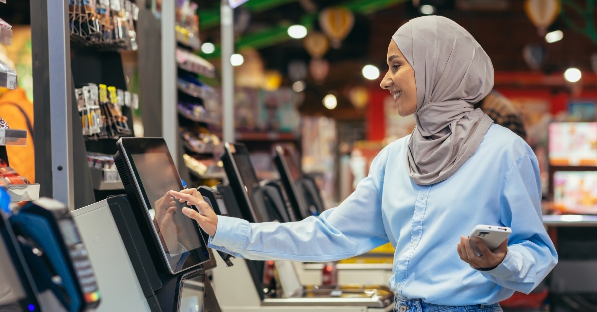 woman in hijab at self checkout