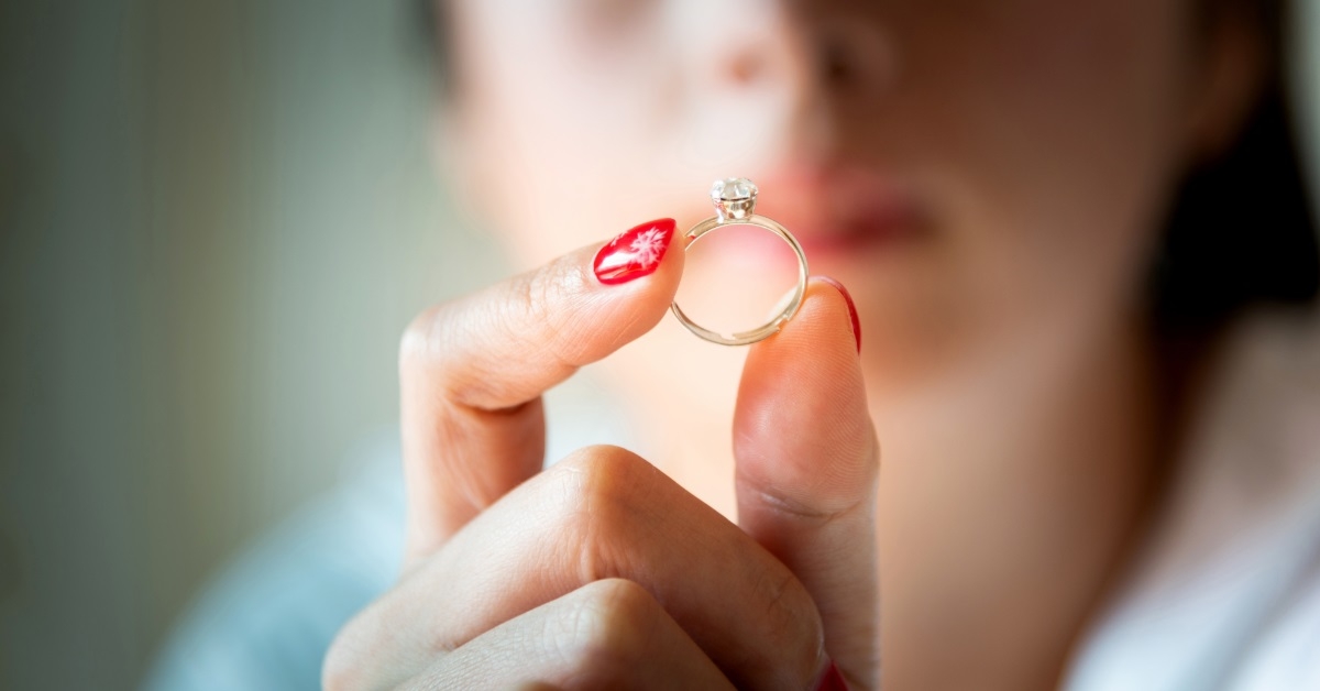 woman holding ring in hand