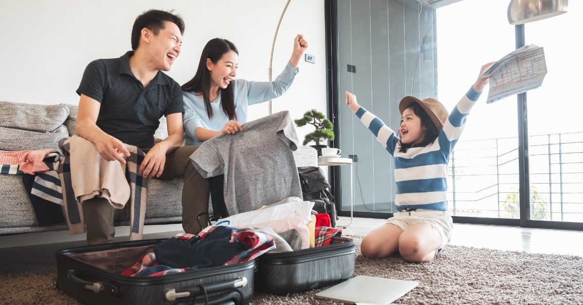 asian family packing luggage for traveling
