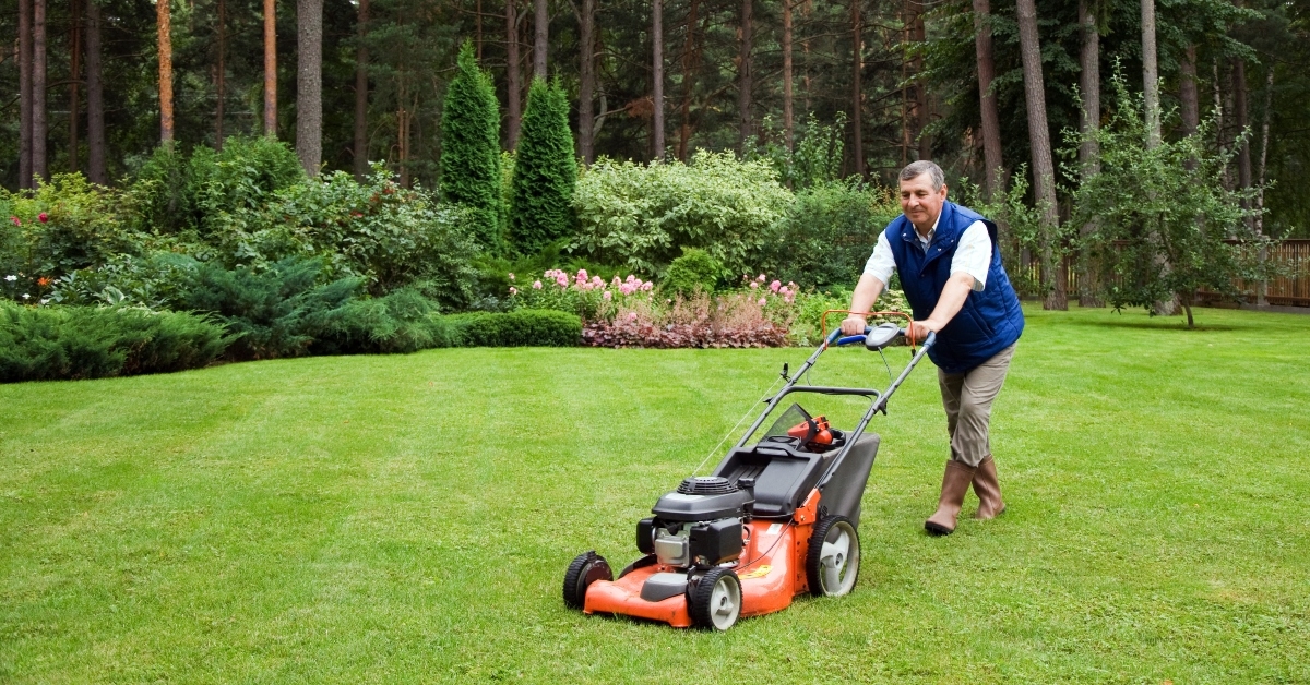 senior man mowing the lawn