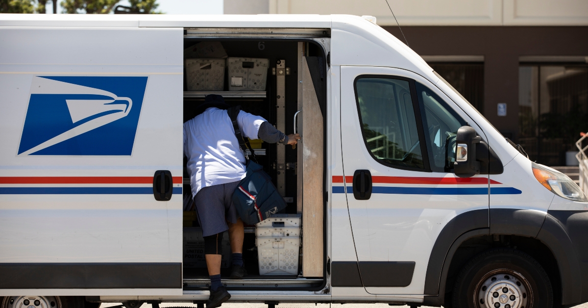 postal worker delivers mail