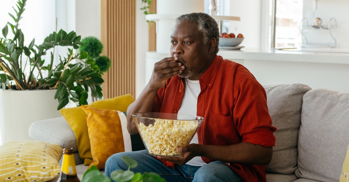 african american man eating popcorn
