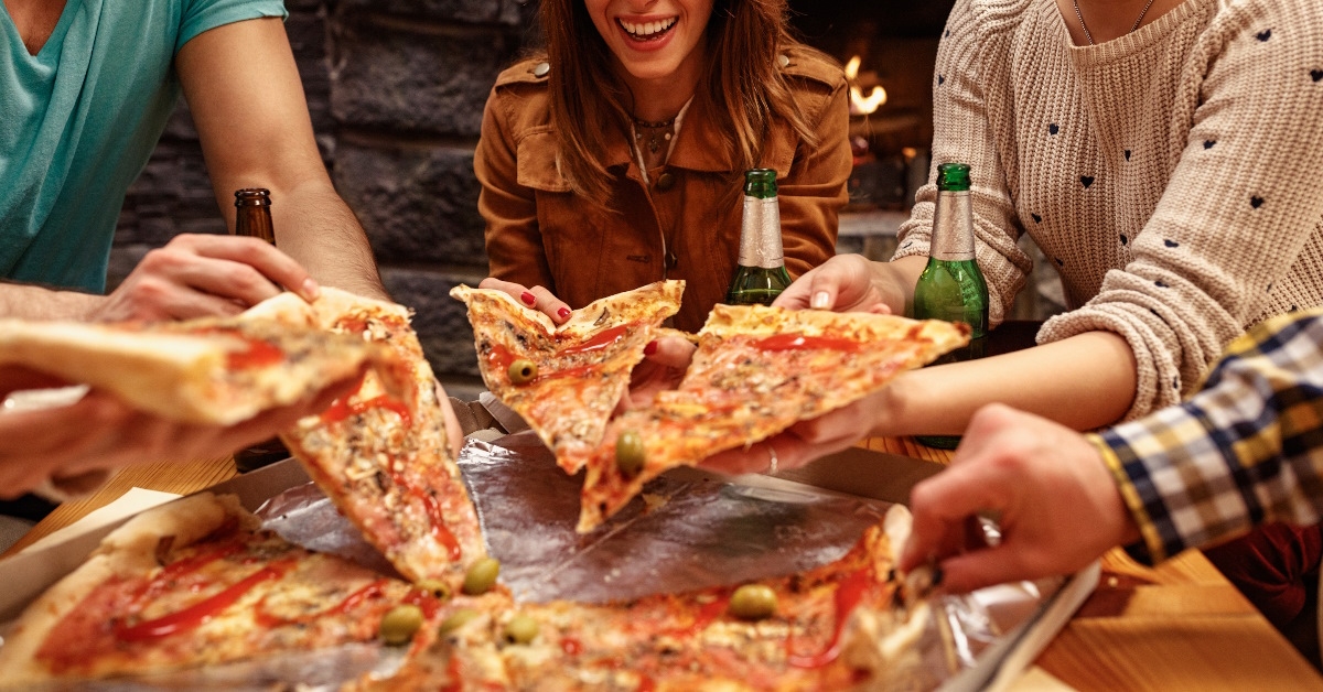 friends enjoying pizza together