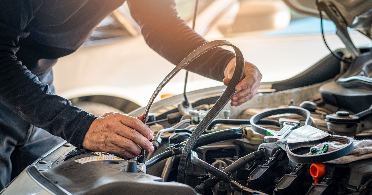 man repairing car timing belt