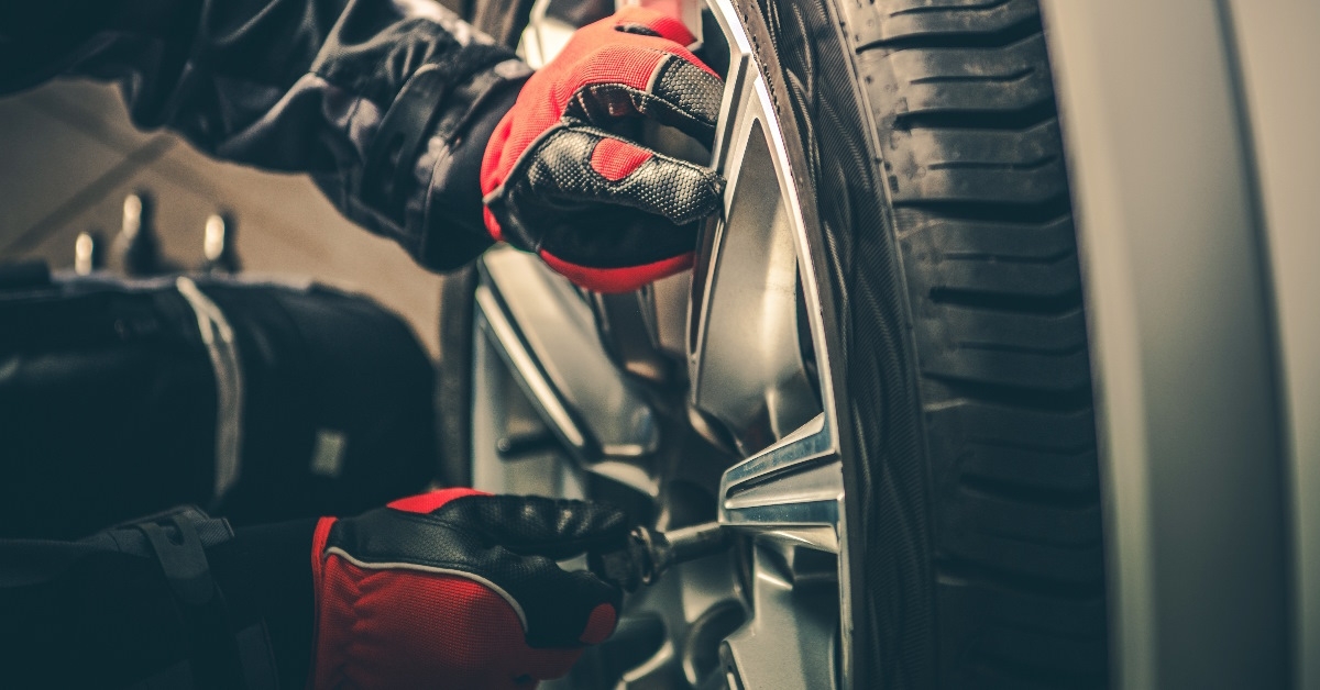 mechanic replacing tires at workshop