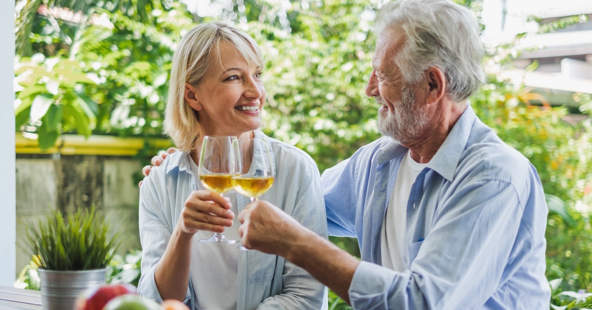 senior couple toasting champagne glasses