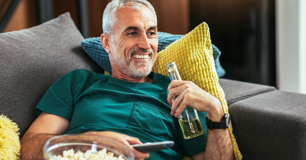 senior man watching tv at home