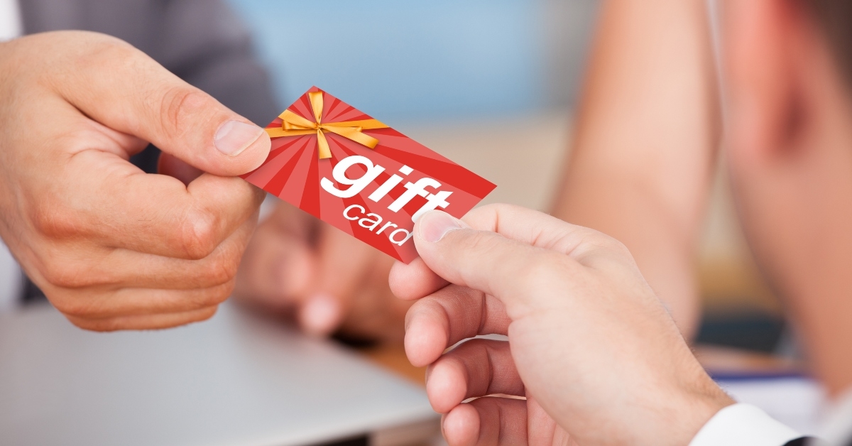 person hand giving gift card