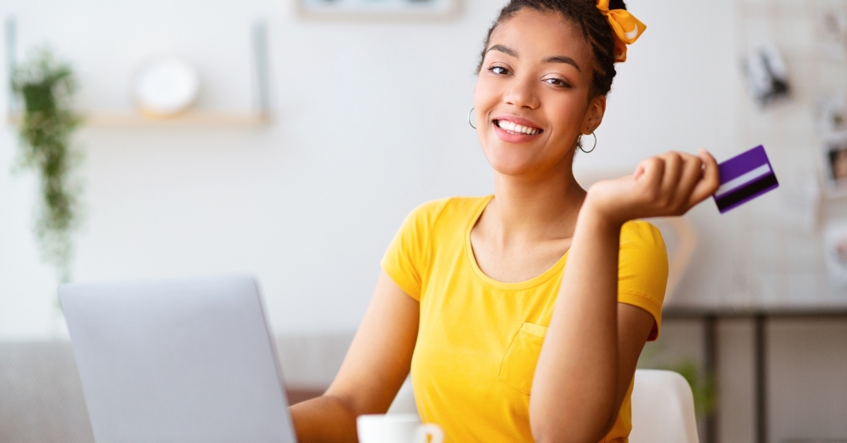 woman using laptop and credit card