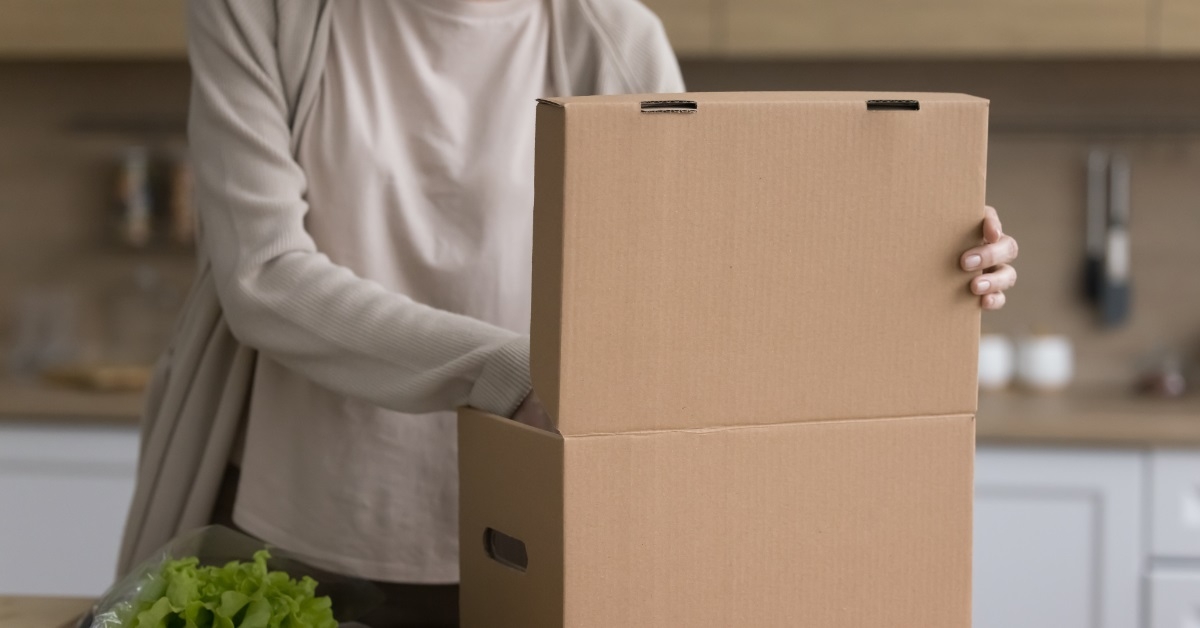 woman unpacking fresh vegetables box