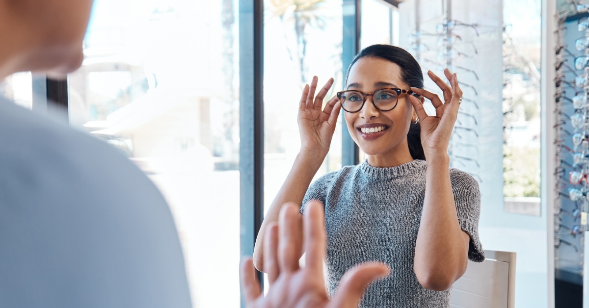 woman trying glasses at optometrist store