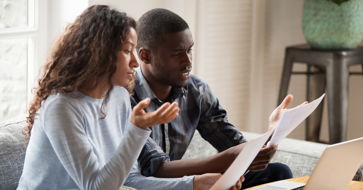 black couple read bills