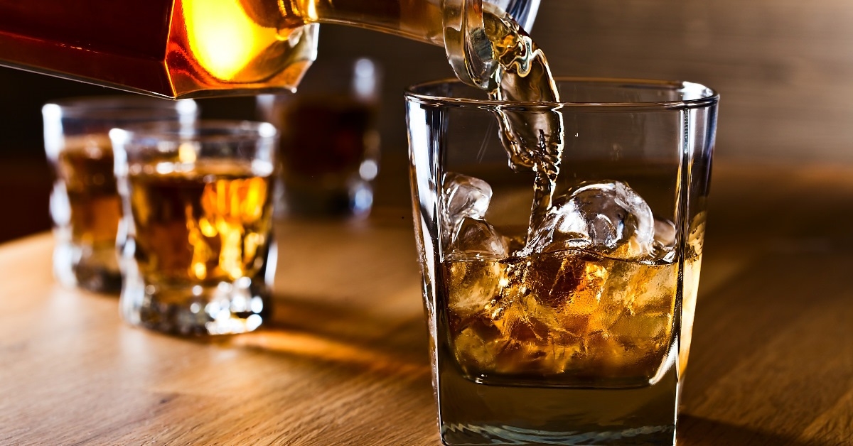 whiskey spilled over ice in glass