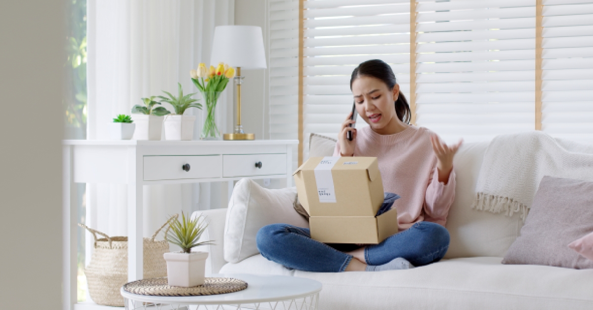 female consumer sits at sofa