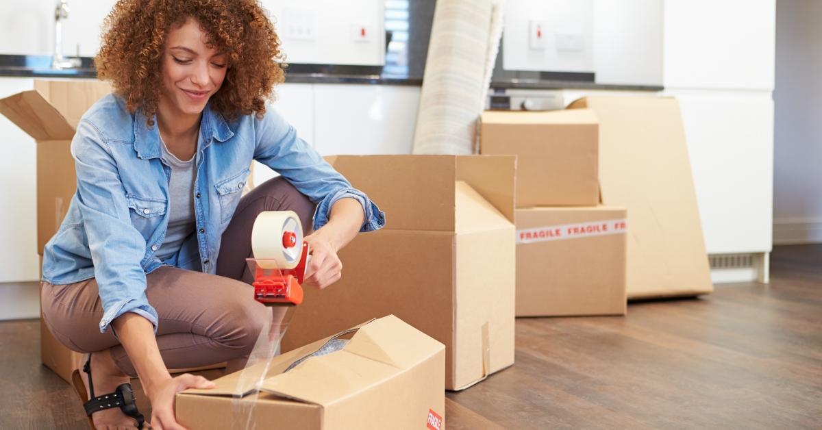 woman sealing boxes