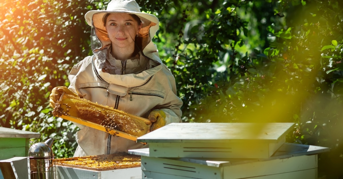 female beekeeper with honey comb