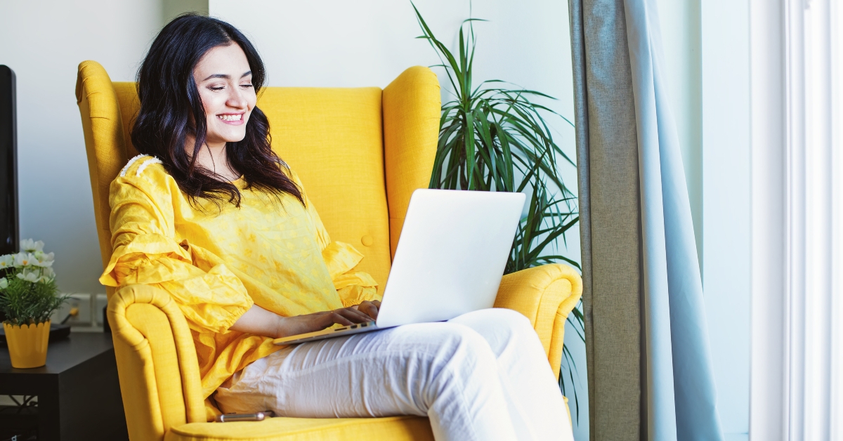 indian woman sitting on yellow armchair