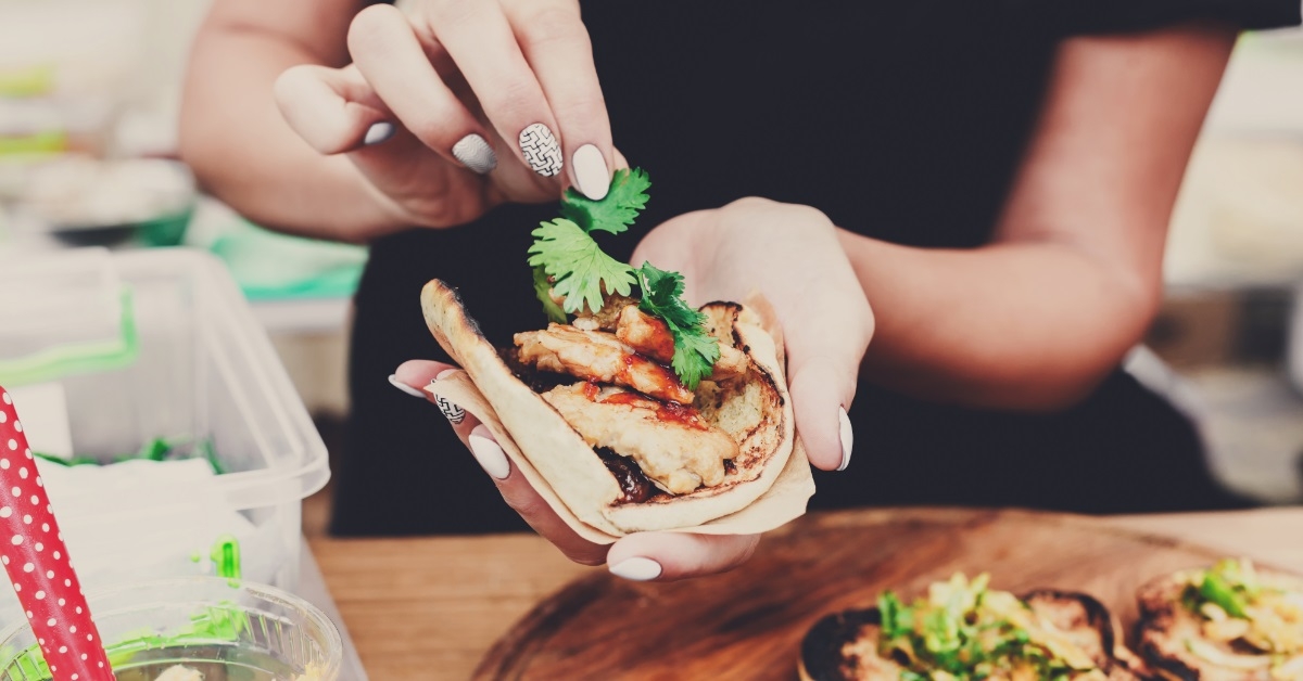 street vendor preparing tacos outdoors