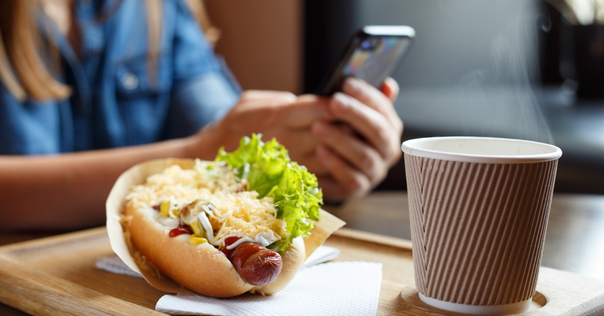 woman with hot dog at cafe