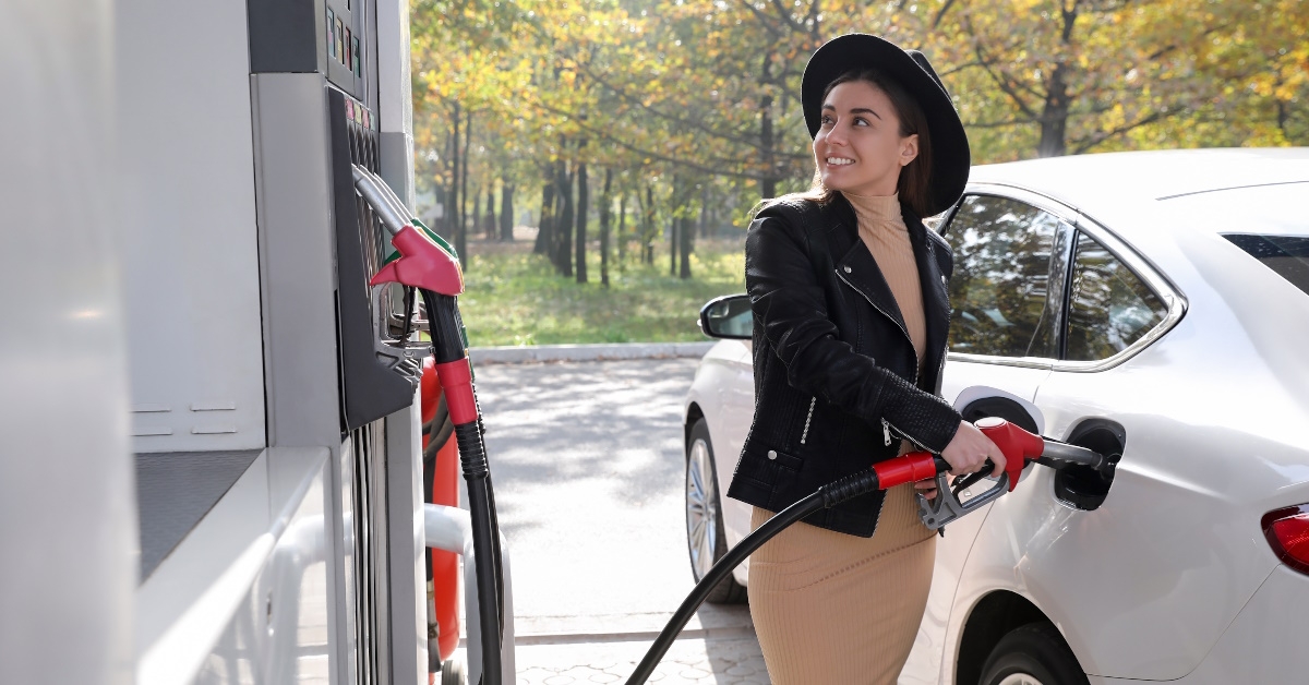 Woman refueling car at gas station