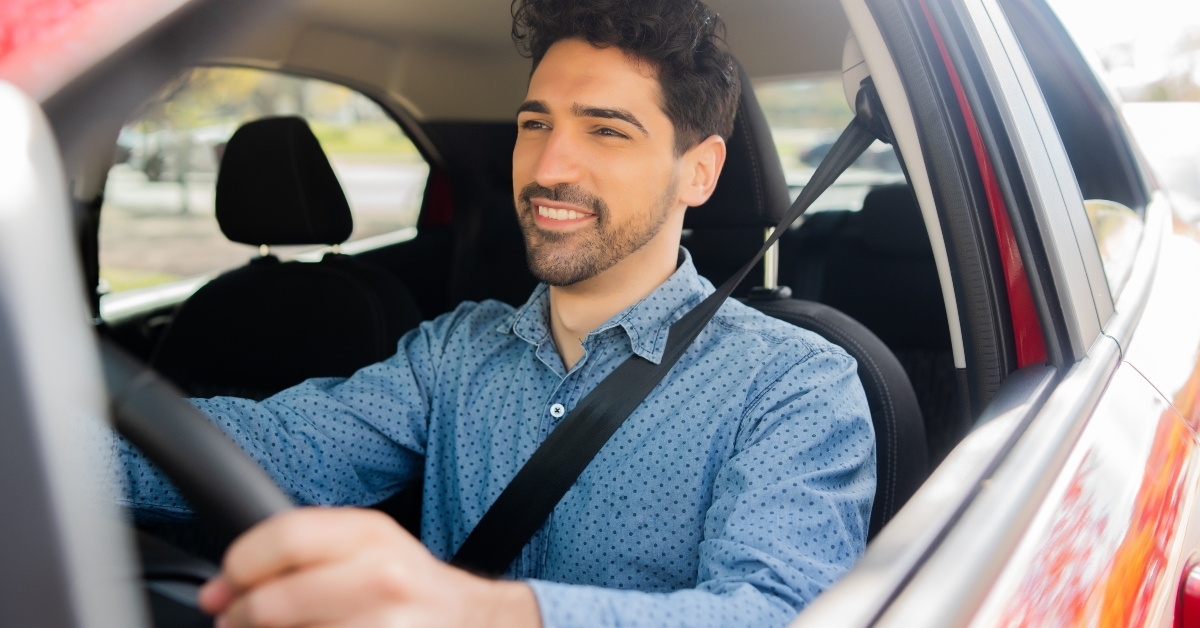 man driving his car