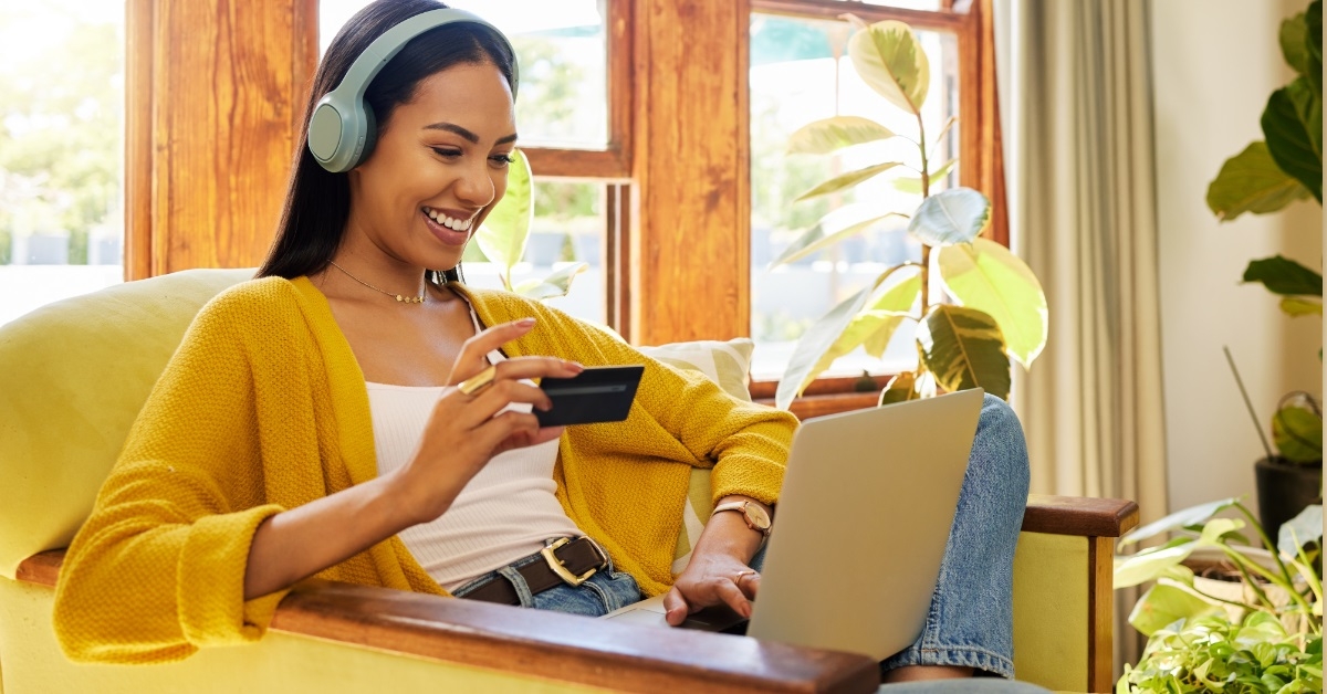 woman shopping on laptop using card