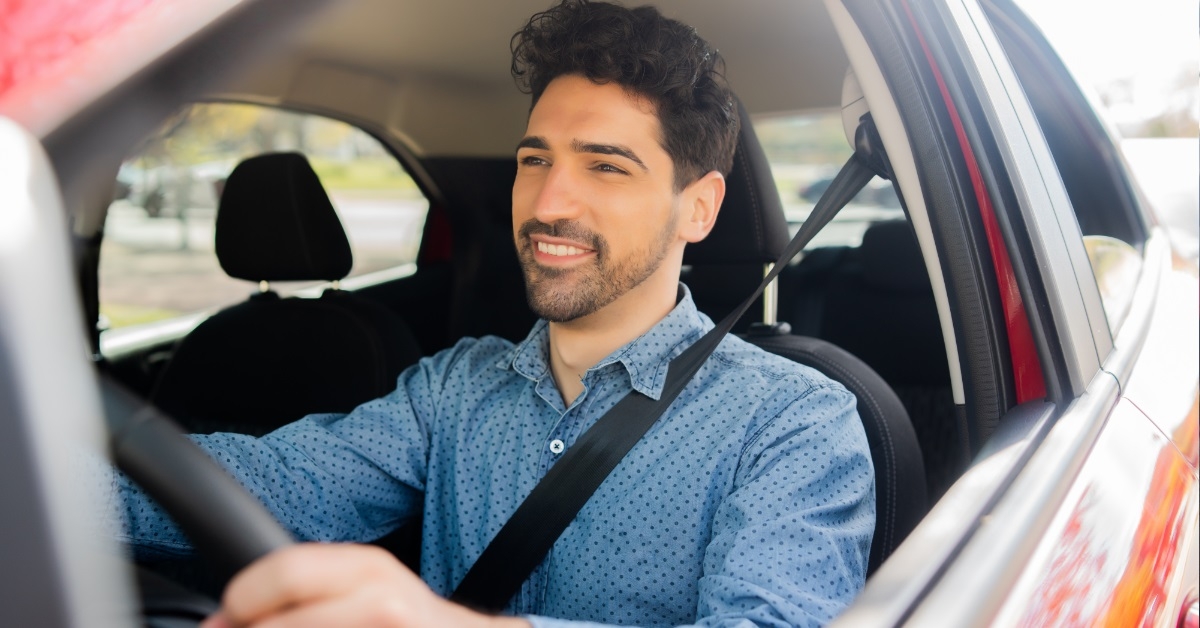man driving in car to office
