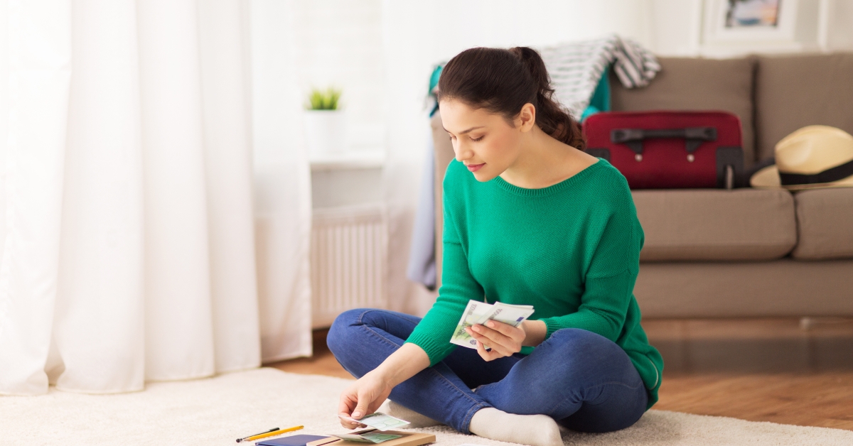 woman with money and travel map
